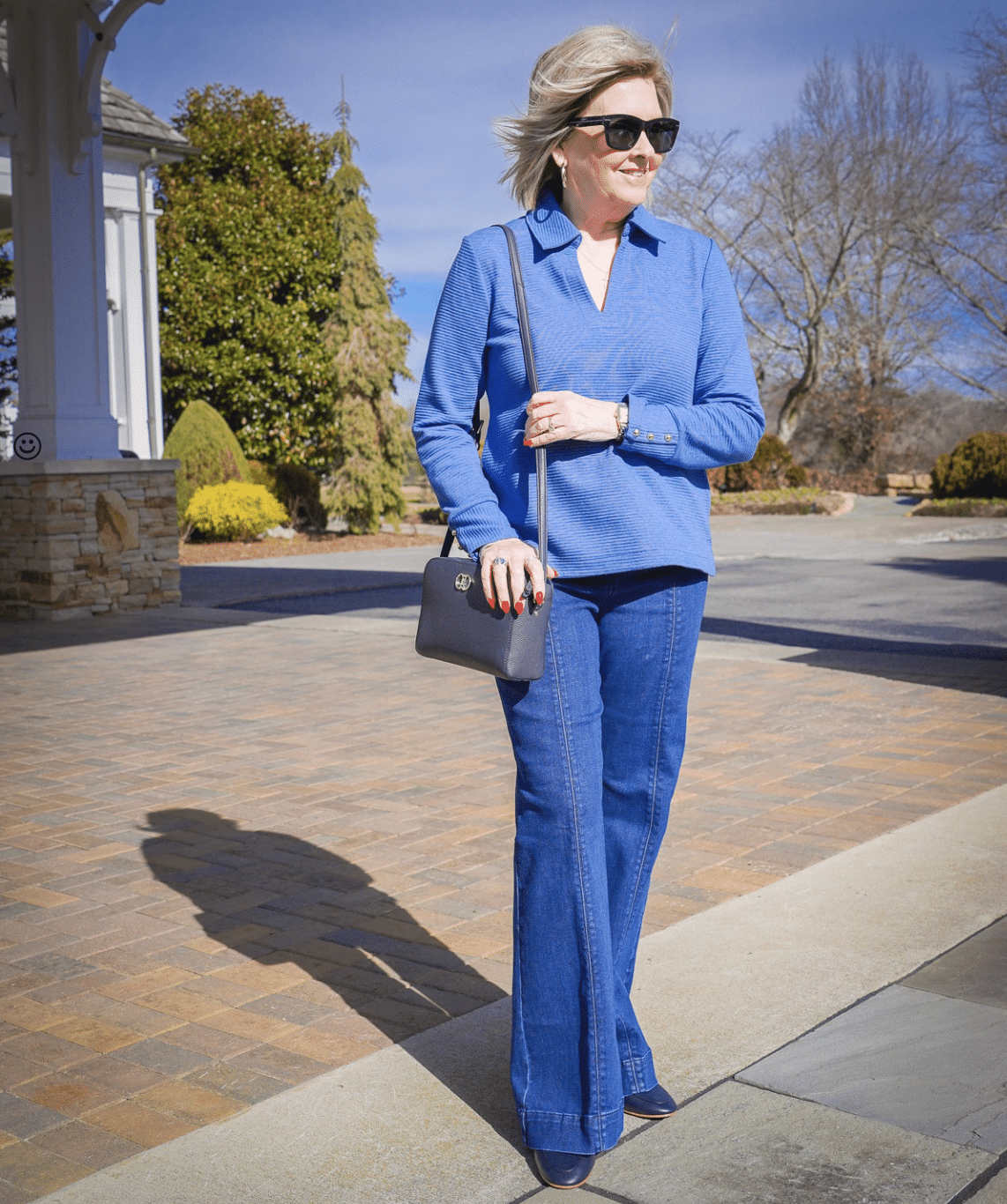 Tania Stephens, over 50 fashion blogger, wearing a blue pullover top and wide leg jeans from Talbots